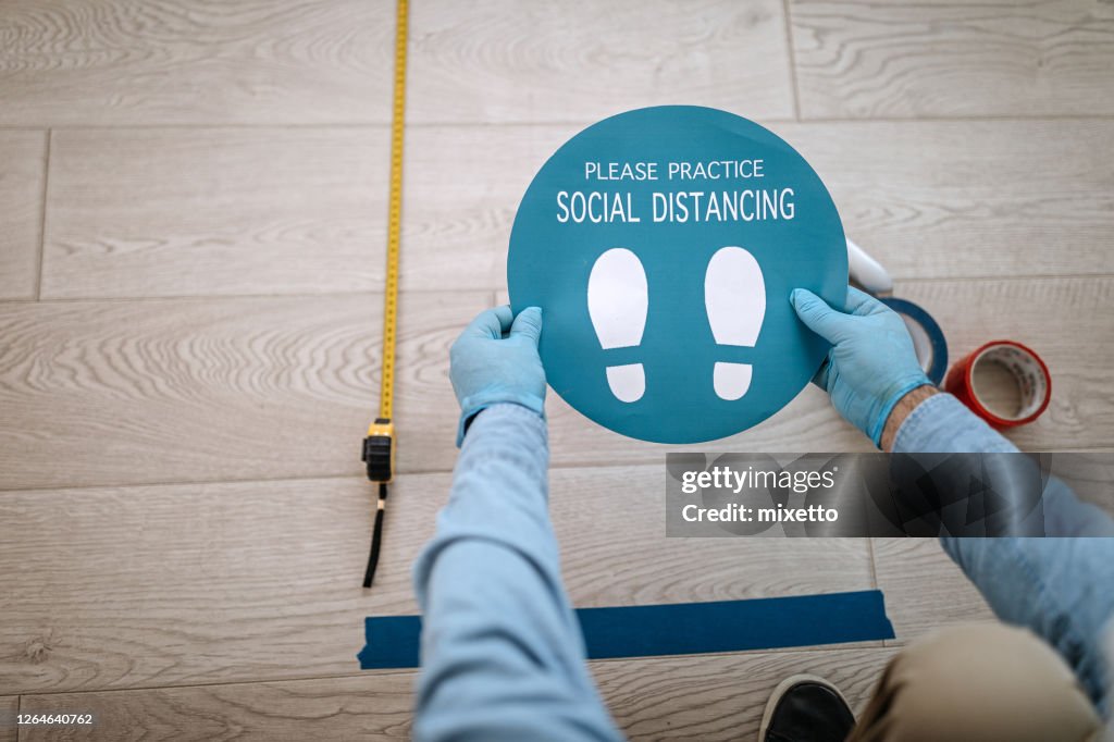 Social Distance Work Signs Man Applying Social Distancing Sign At Office High-Res Stock Photo ...