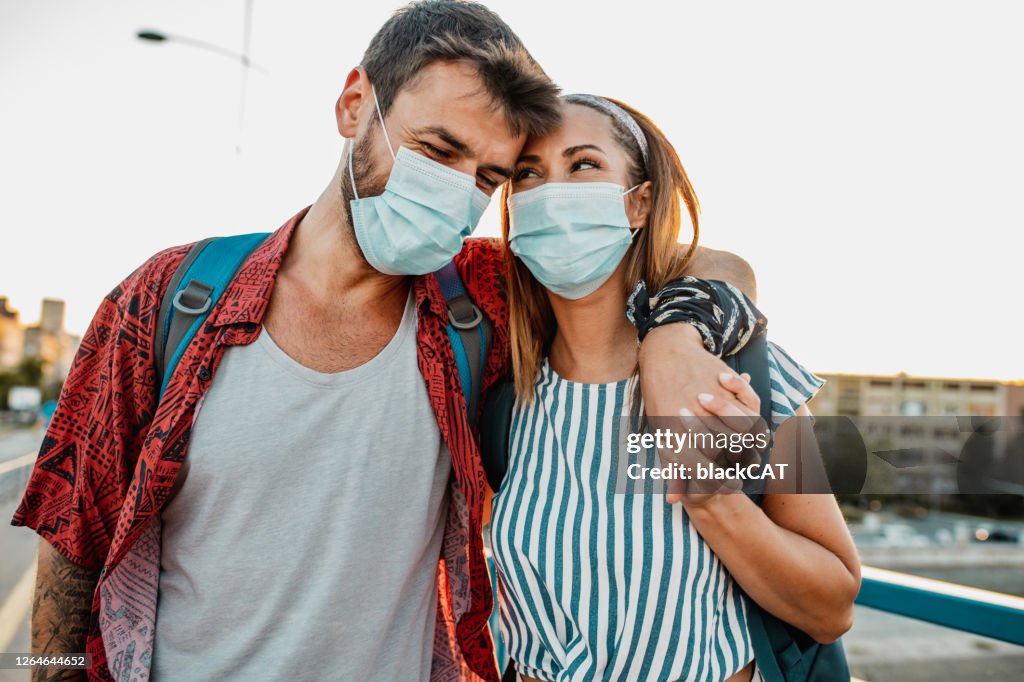 A young couple in love with face masks