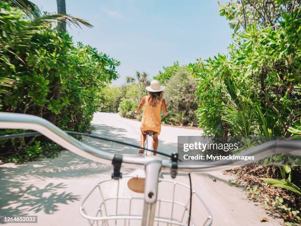 pov point of view of couple cycling on tropical island - 2 point perspective stock pictures, royalty-free photos & images