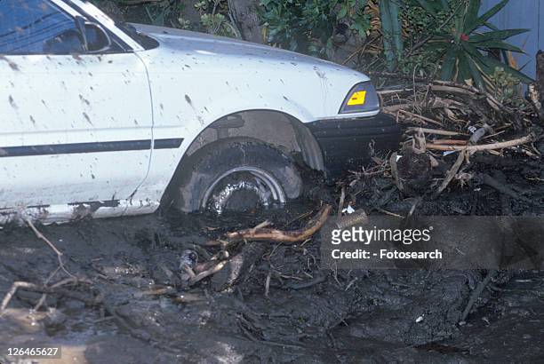 a small car stuck after the mudslides - california mudslides stockfoto's en -beelden
