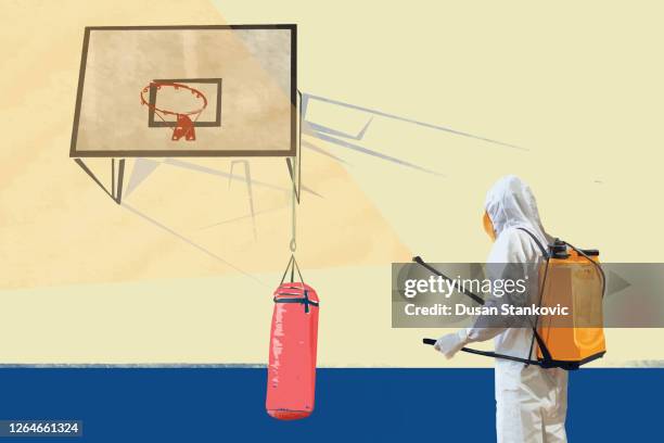 ilustrações de stock, clip art, desenhos animados e ícones de worker in protective suit disinfecting school gym - saco-de-boxe
