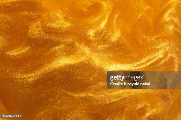 gold paint dissolved in water - glamour stock pictures, royalty-free photos & images