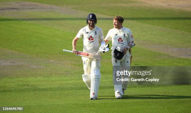 Chris Woakes and Dom Bess of England walk off after victory on Day Four of the 1st #RaiseTheBat Test Match between England and Pakistan at Emirates...