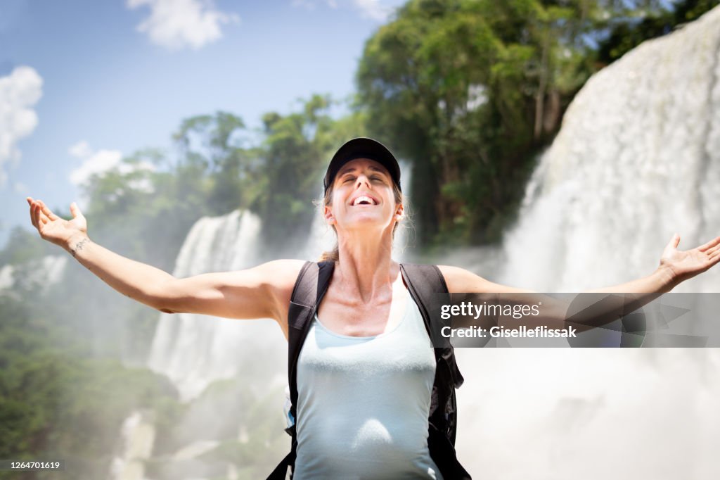 Tourist having fun in Iguazu falls