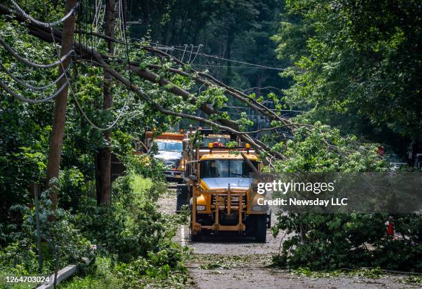 The Northern Blvd in Oyster Bay, New York shows that there's still a lot of repair work to be done as a PSEG utility truck drives through trees...