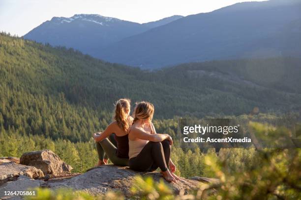 年輕女性在岩石板上放鬆, 看看。 - clothes on clothes off photos 個照片及圖片檔