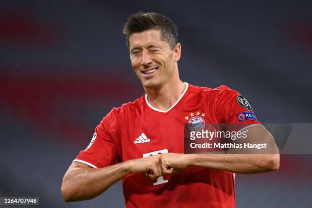 Robert Lewandowski of Bayern Munich celebrates after he scores his sides first goal from the penalty spot during the UEFA Champions League round of...
