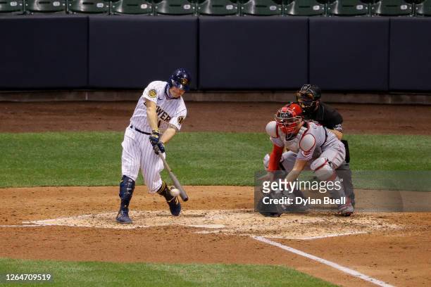 Brock Holt of the Milwaukee Brewers hits a single in the sixth inning against the Cincinnati Reds at Miller Park on August 07, 2020 in Milwaukee,...