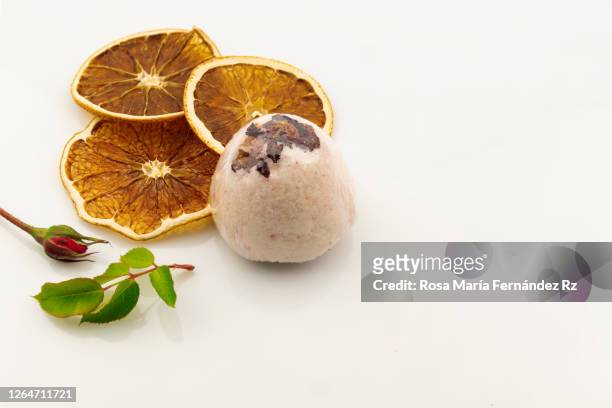 homemade bath bombs, rose petals and slices orange dehydrated on  white background. directly above and negative space for text. natural cosmetics. - white rose flower spa stock-fotos und bilder