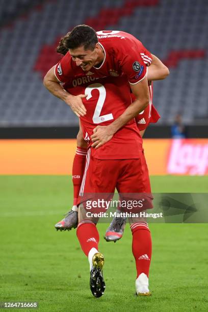 Robert Lewandowski of Bayern Munich celebrates with Alvaro Odriozola Arzallus of Bayern Munich after scoring his sides fourth goal during the UEFA...