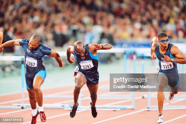 Mark Crear of the USA, Allen Johnson of the USA, and Terrence Trammell of the USA lunge across the finish line of the Men's 110 meters hurdles final...