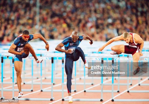 Terrence Trammell of the USA, Allen Johnson of the USA , and Stanislavs Olijars of Latvia compete in the Men's 110 meters hurdles semifinal of the...
