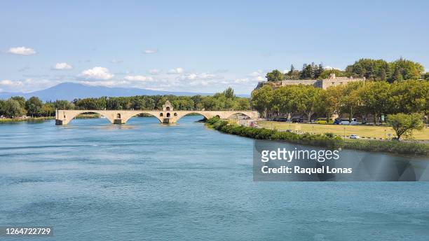 rhone river and pont d'avignon, also known as pont saint-benezet, over the rhone river in avignon, france - rhone stock pictures, royalty-free photos & images