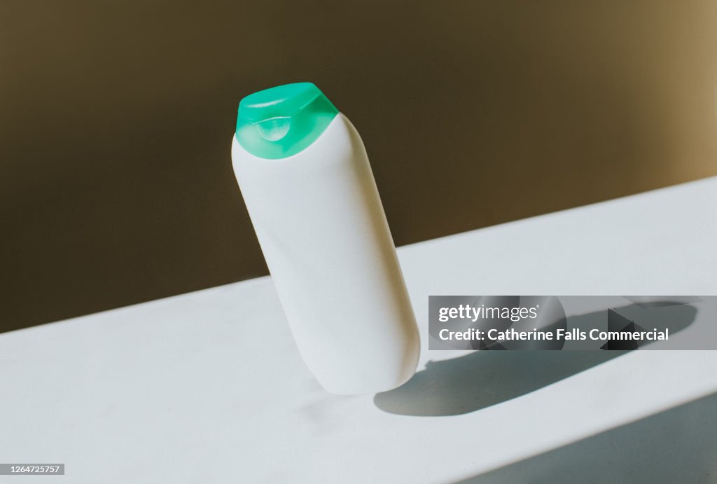 Plain white bottle in mid-air casting a Shadow