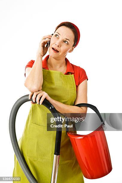 woman with vacuum cleaner and cleaning bucket phoning - vacuum cleaner woman stockfoto's en -beelden