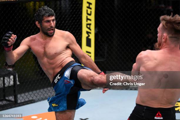 Beneil Dariush of Iran kicks Scott Holtzman in their lightweight fight during the UFC Fight Night event at UFC APEX on August 08, 2020 in Las Vegas,...