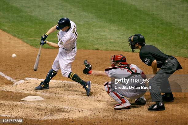 Brock Holt of the Milwaukee Brewers hits a sacrifice fly in the eighth inning against the Cincinnati Reds at Miller Park on August 08, 2020 in...