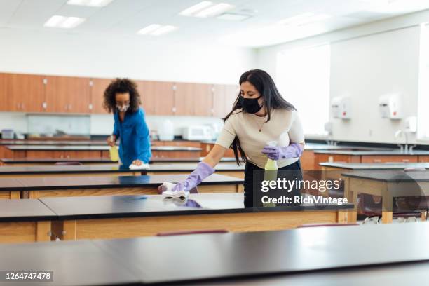 high school teachers cleaning classroom during covid-19 - campus safety stock pictures, royalty-free photos & images