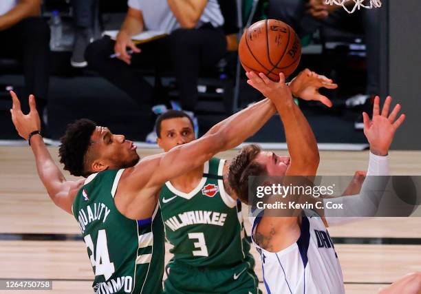 H34\ blocks a shot by Luka Doncic of the Dallas Mavericks as George Hill of the Milwaukee Bucks looks on at The Arena at ESPN Wide World Of Sports...