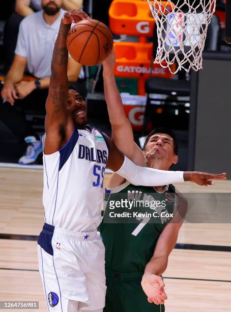 Ersan Ilyasova of the Milwaukee Bucks knocks the ball from the hands of Delon Wright of the Dallas Mavericks at The Arena at ESPN Wide World Of...