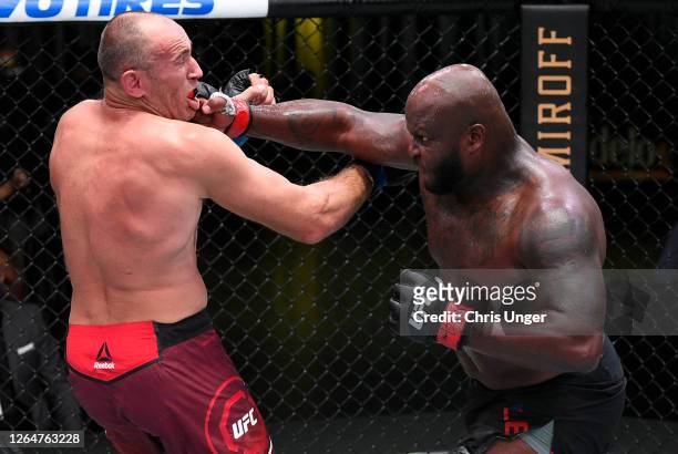 Derrick Lewis punches Aleksei Oleinik of Russia in their heavyweight fight during the UFC Fight Night event at UFC APEX on August 08, 2020 in Las...