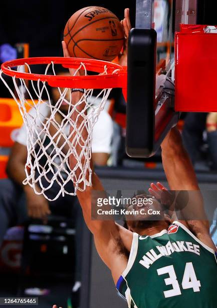 Giannis Antetokounmpo of the Milwaukee Bucks goes up for a shot against the Dallas Mavericks during overtime at The Arena at ESPN Wide World Of...