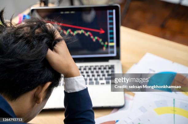 stock trader tearing out his hair from despair, rear view - deterioration stock pictures, royalty-free photos & images
