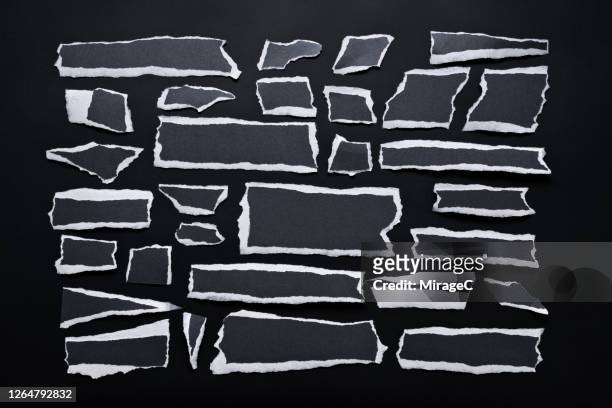 torn black paper pieces with white edge - riss stock-fotos und bilder