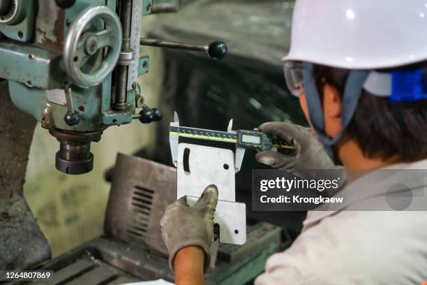 engineer using vernier for measure the test piece on the machine. - calliper stock pictures, royalty-free photos & images