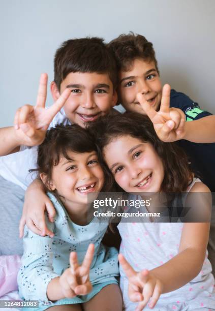 siblings and cousins cheering ​​at home - cousin stock pictures, royalty-free photos & images