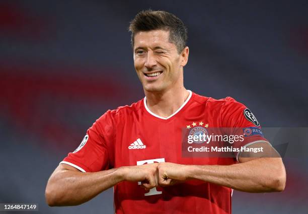 Robert Lewandowski of Bayern Munich celebrates after he scores his sides first goal from the penalty spot during the UEFA Champions League round of...