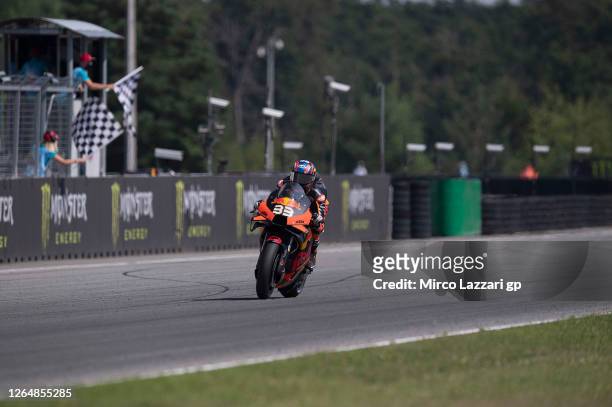 Brad Binder of South Africa and Red Bull KTM Factory Racing cuts the finish lane and celebrates the victory at the end of the MotoGP race during the...