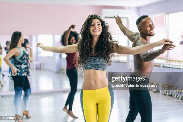 couple dancers practicing in studio, holding hands - samba dancer imagens e fotografias de stock