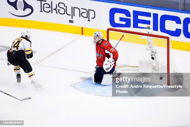 Jake DeBrusk of the Boston Bruins scores a goal on Braden Holtby of the Washington Capitals during the third period in an Eastern Conference Round...