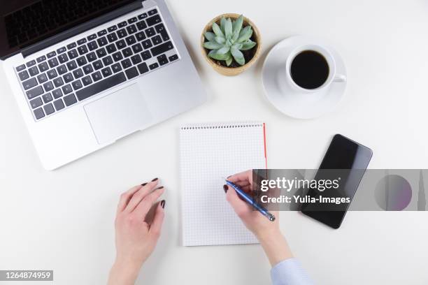 businesswoman writing notes on a blank notepad - doing household chores stock pictures, royalty-free photos & images