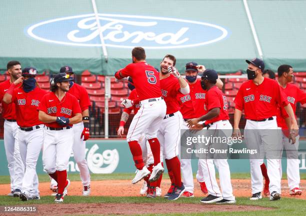 Mitch Moreland of the Boston Red Sox celebrates with the team after hitting a game winning home run in the bottom of the ninth inning against the...