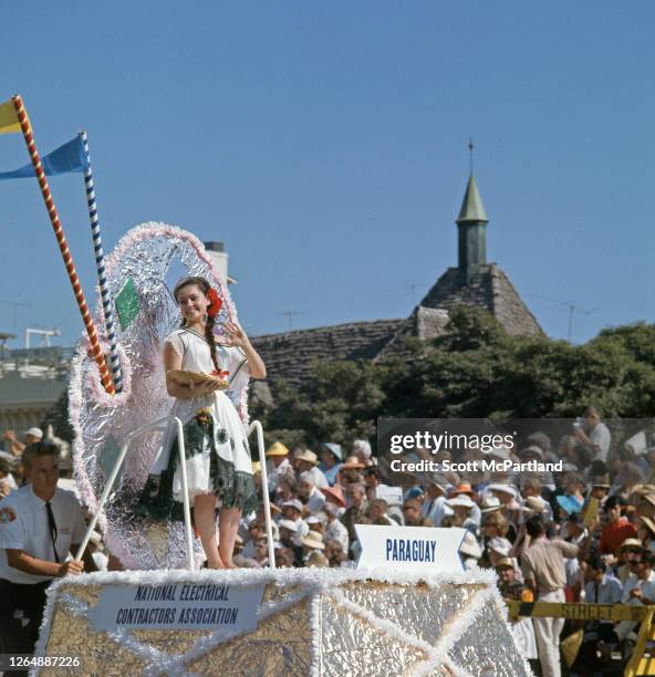 View of Miss Paraguay, Maria Elena Quesda, as she waves from a small parade float being pushed along Ocean Boulevard during the International Beauty...