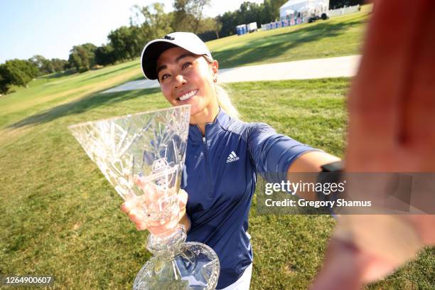 Danielle Kang imitates a “selfie” as she poses with the trophy after winning the Marathon LPGA Classic during the final round at Highland Meadows...
