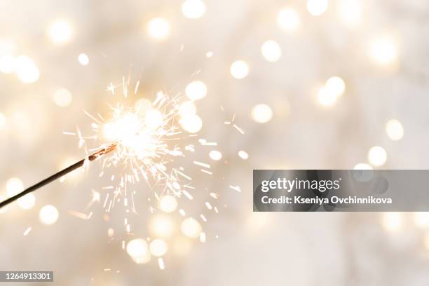 christmas glittering sparklers. decoration lighting element. festive magic sparks lights for holiday poster, birthday or party concept. xmas decoration lighting element. - sparkler stock photos et images de collection