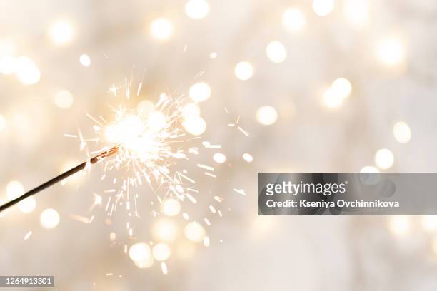 christmas glittering sparklers. decoration lighting element. festive magic sparks lights for holiday poster, birthday or party concept. xmas decoration lighting element. - sparklers stockfoto's en -beelden