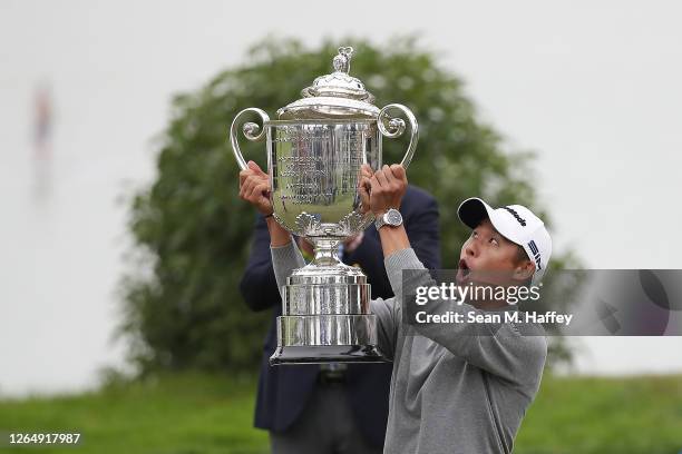 Collin Morikawa of the United States reacts as the lid to the Wanamaker Trophy falls off during the trophy presentation after the final round of the...