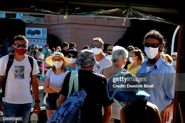 Tourist wearing masks travel by boat from Dubrovnik to the island Lokrum in Dubrovnik on July 26, 2020 in Dubrovnik, Croatia. Located in southern...