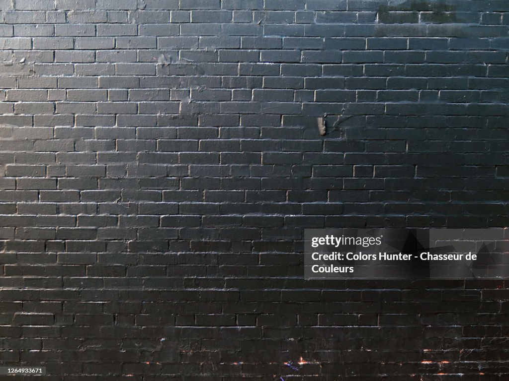 Montreal Brick wall painted in black under natural light