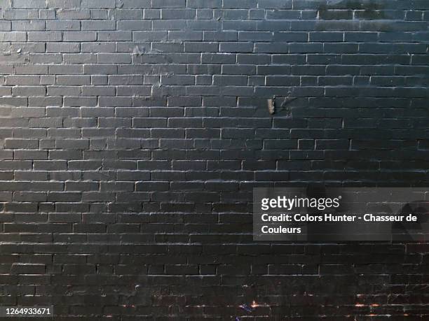 montreal brick wall painted in black under natural light - brick wall stock pictures, royalty-free photos & images