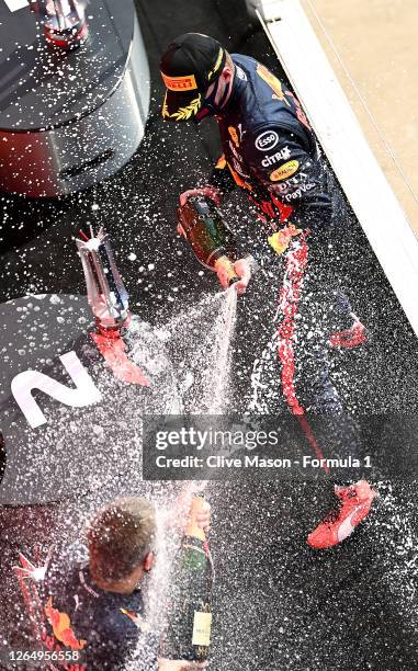 Race winner Max Verstappen of Netherlands and Red Bull Racing sprays Champagne on the podium after the F1 70th Anniversary Grand Prix at Silverstone...