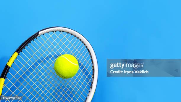 sport concept with tennis ball and racket on blue hard tennis court. - tennis raquet close up photos et images de collection