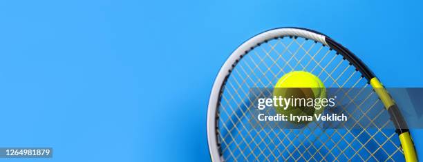 sport concept with tennis ball and racket on blue hard tennis court. - blue tennis racket stock pictures, royalty-free photos & images