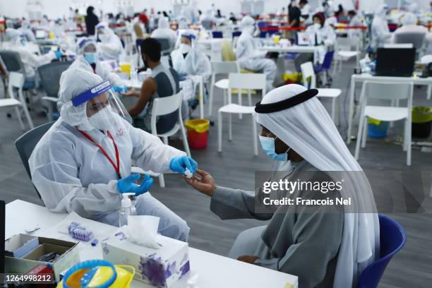 Man is tested using Laser-based DPI technology at a testing center at the Dubai-Abu Dhabi border on August 10, 2020 in Abu Dhabi, United Arab...