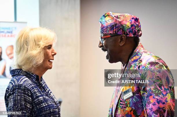 Britain's Queen Camilla speaks with Jamaican-born British fitness instructor Derrick Errol Evans also known as Mr Motivator during a reception...