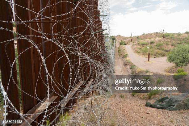 the us/mexico border fence in nogales, arizona usa - immigration law stock-fotos und bilder